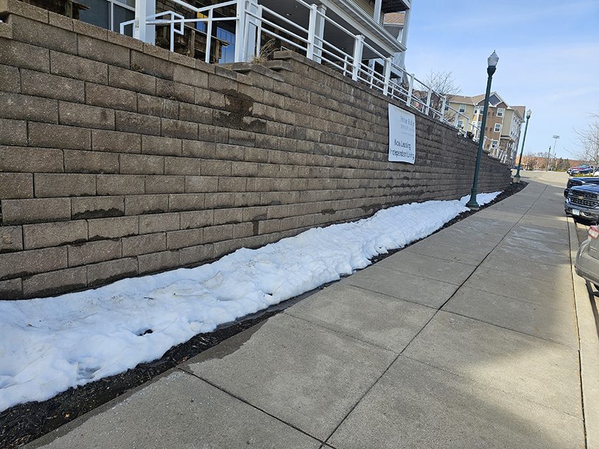 Commercial block retaining wall before replacement at a senior living property | Granite Companies MN