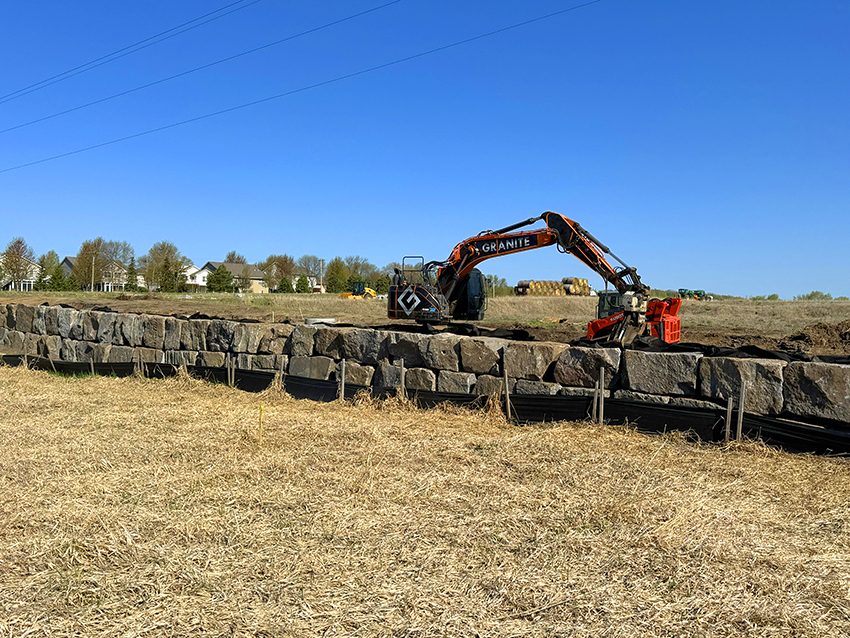 Equipment Escavator With Rotator Working On Granite Wall | Granite Companies MN