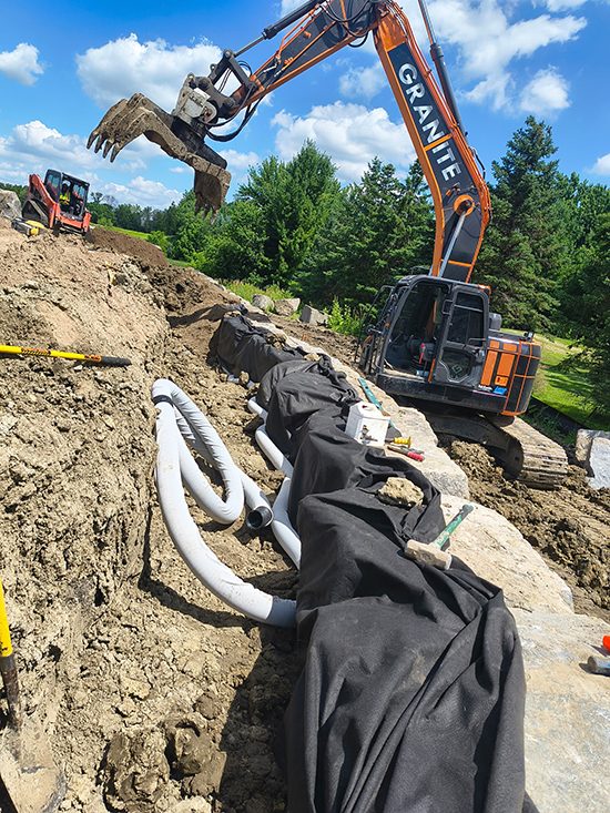 Equipment Granite Companies Excavator Granite Wall Construction | Granite Companies MN