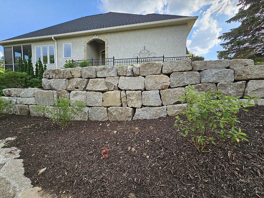 Residential new granite boulder wall after replacement | Granite Companies MN