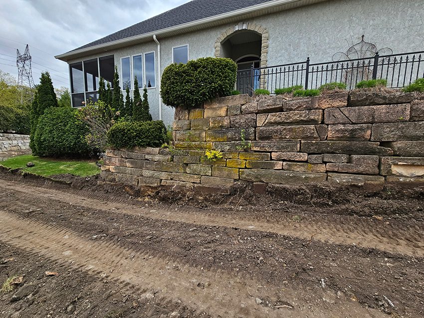 Residential old stone wall before granite replacement | Granite Companies MN