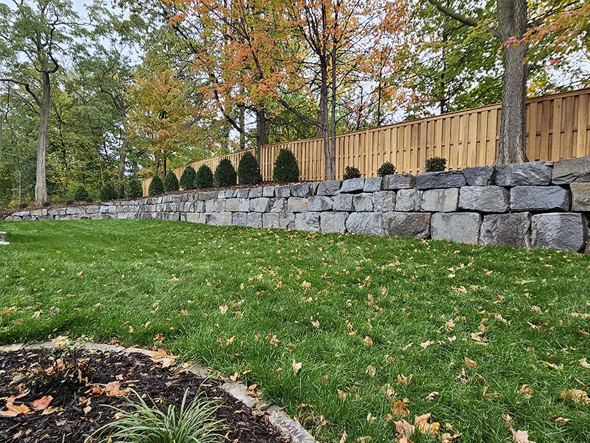 Residential Granite Boulder Retaining Wall In A Backyard | Granite Companies MN