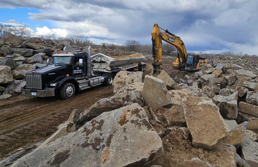 Granite Companies truck and excavator working at granite quarry MN
